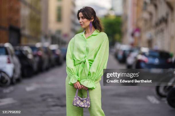 Ketevan Giorgadze @katie.one wears long metal H&M earrings decorated with faceted plastic beads, a linen green oversized lounge The Sleeper shirt...