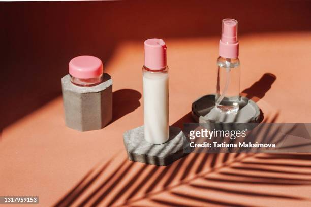 blank glass cosmetic bottles on different shape podiums from concrete. - fashion blogger stock-fotos und bilder