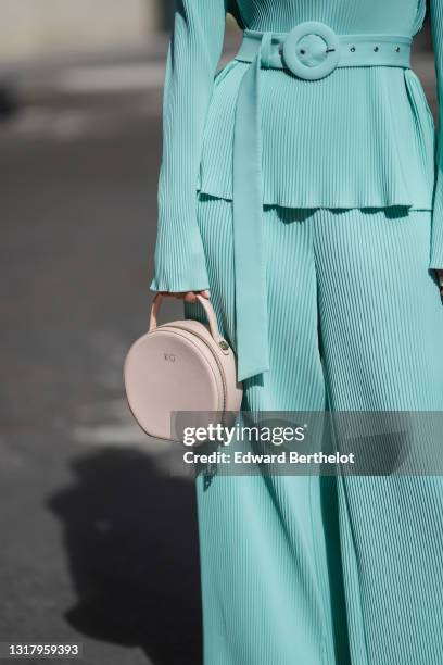 Ketevan Giorgadze @katie.one wears a pale blue oversized belted chiffon lightweight handmade plissé long sleeves top with matching J'Amemme oversized...