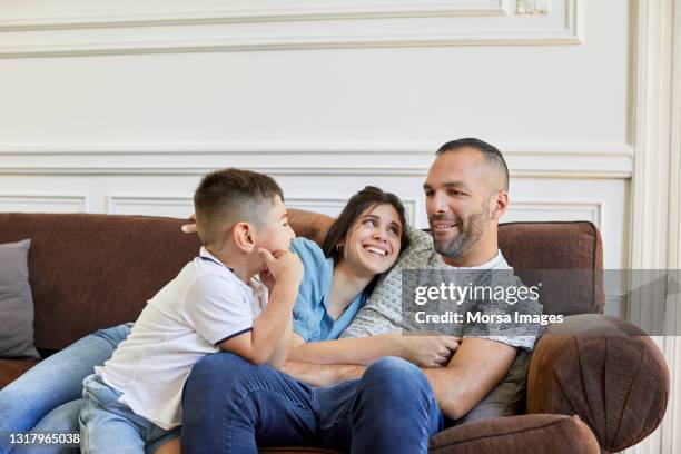 family enjoying in living room during coronavirus - familie sofa stock pictures, royalty-free photos & images