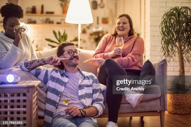 movie night at home with friends - watching tv couple night stock pictures, royalty-free photos & images