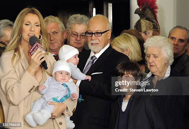 Singer Celine Dion holds her son Nelson Angelil and husband and manager Rene Angelil, holds their son Eddy Angelil next to Rene-Charles Angelil and...