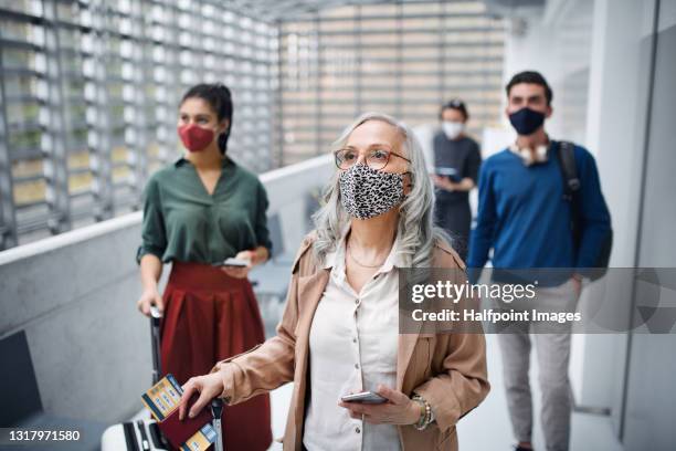 group of people in airport lounge or station, coronavirus, travel and new normal. - new normal concept stockfoto's en -beelden