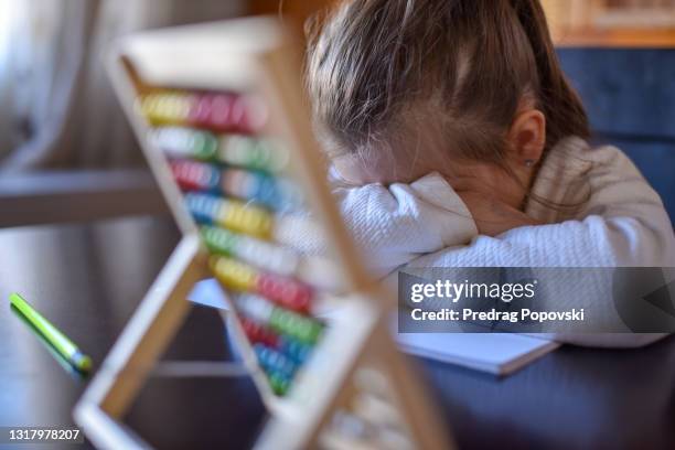 sad child crying behind abacus , trying to learn multiplication table - sad kid in kindergarten stock pictures, royalty-free photos & images