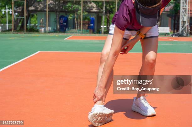 runner woman suffering from ankle pain because of overtraining. - caviglia foto e immagini stock