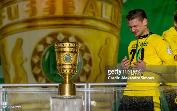 Lukasz Piszczek of Borussia Dortmund looks at the trophy after the DFB Cup final match between RB Leipzig and Borussia Dortmund at Olympic Stadium on...
