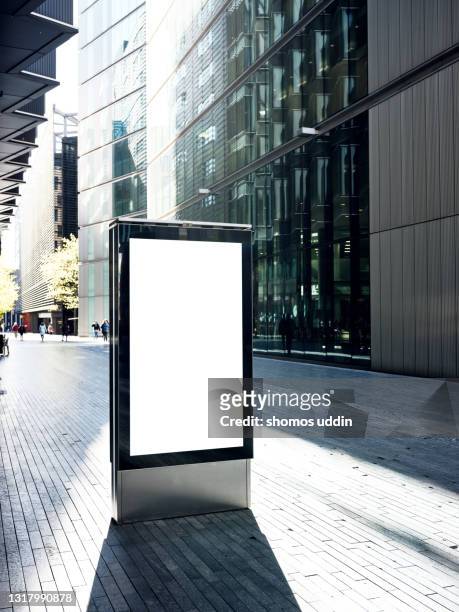blank electronic billboard on busy street in london - vertical foto e immagini stock