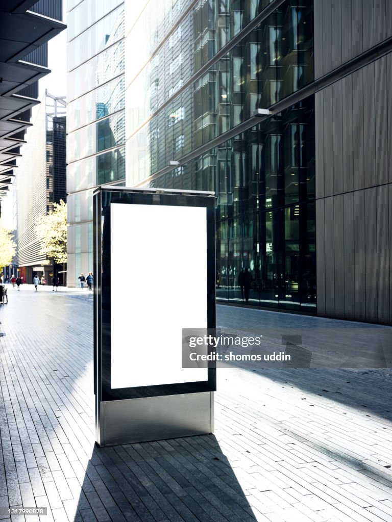 Blank electronic billboard on busy street in London