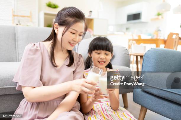 mother and daughter drink milk - milk family stock pictures, royalty-free photos & images