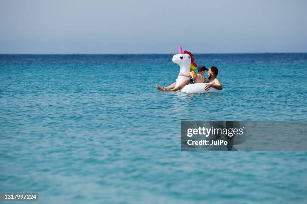 man on floating unicorn - man on float stock pictures, royalty-free photos & images