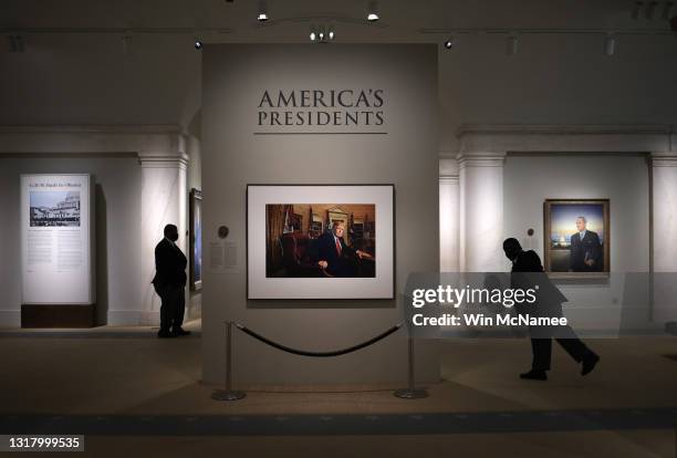 Patrons and security guards view a portrait of former U.S. President Donald Trump in the America’s Presidents exhibition at the National Portrait...