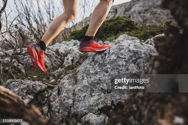 trail runner running and climbing on mountains. active health and motivation lifestyle. - trailrunning stock pictures, royalty-free photos & images