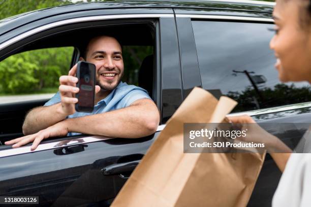 man uses mobile app to pick up food order - the lift presented stock pictures, royalty-free photos & images