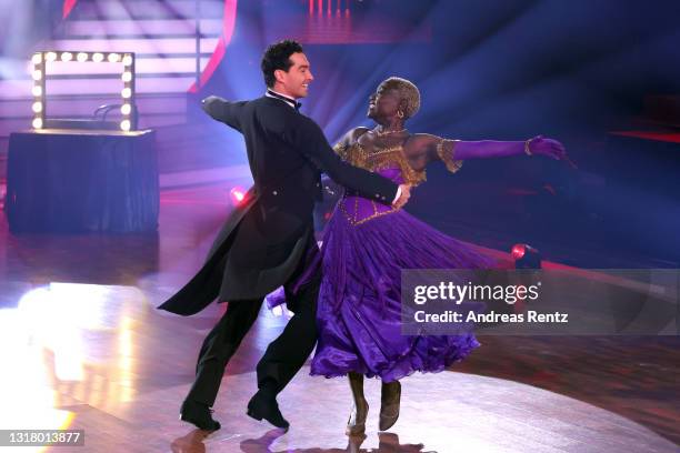 Auma Obama and Andrzej Cibis perform on stage during the 10th show of the 14th season of the television competition "Let's Dance" on May 14, 2021 in...