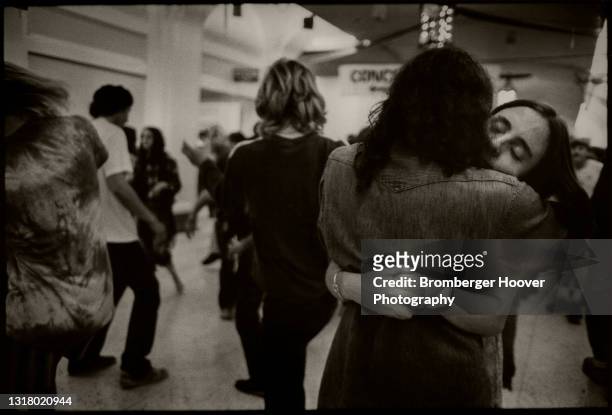 View of a young couple as they embrace on a concourse at Bill Graham Auditorium, San Francisco, California, January 28, 1987. They were there to...