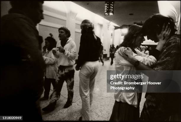 View of a young couple as they press their foreheads together on a concourse at Bill Graham Auditorium, San Francisco, California, January 28, 1987....