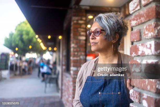 senior black business owner outside her store - hairdressers black woman stock pictures, royalty-free photos & images