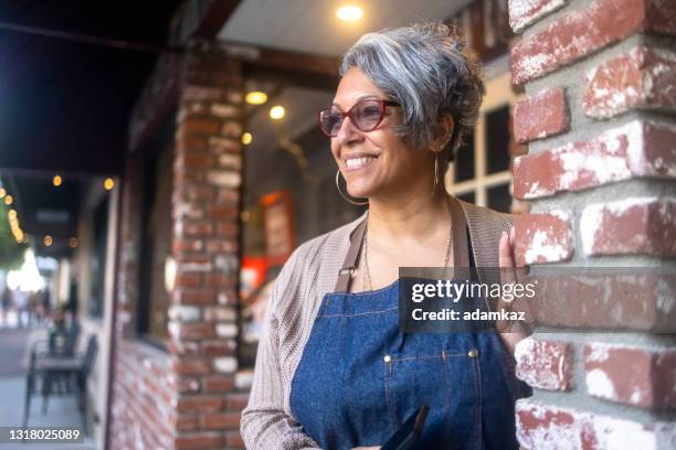 senior black business owner outside her store - bakery apron stock pictures, royalty-free photos & images