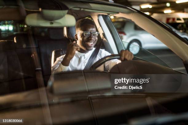 happy african american businessman listening to music while driving his car. - car listening to music imagens e fotografias de stock