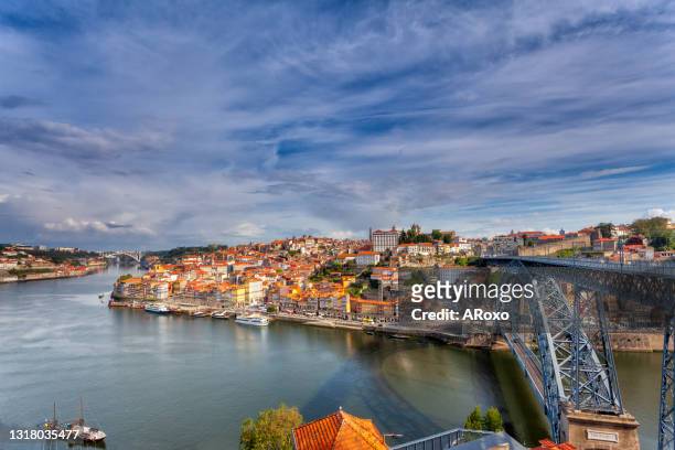 oporto, portugal, europe. postcard from the picturesque city of porto, amazing travel destination in portugal. view to the historic center, douro river with its beautiful bridge and old monuments. - ribeira porto stock pictures, royalty-free photos & images