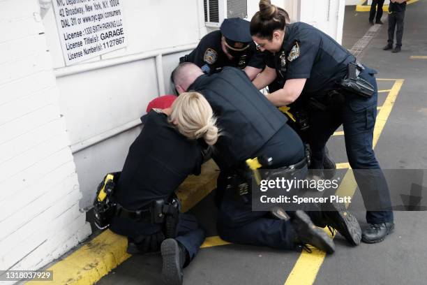 Police arrest a pro-Palestinian demonstrator at a rally against recent Israeli actions against the Palestinians on May 14, 2021 in New York City....