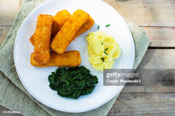 fish sticks with mashed potatoes and spinach - fish fingers stockfoto's en -beelden