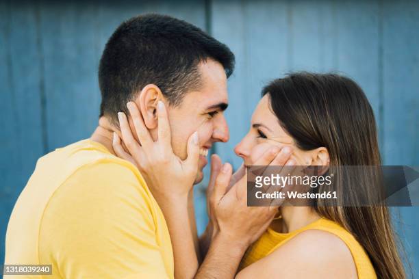 affectionate couple smiling while looking at each other - straight hair ストックフォトと画像