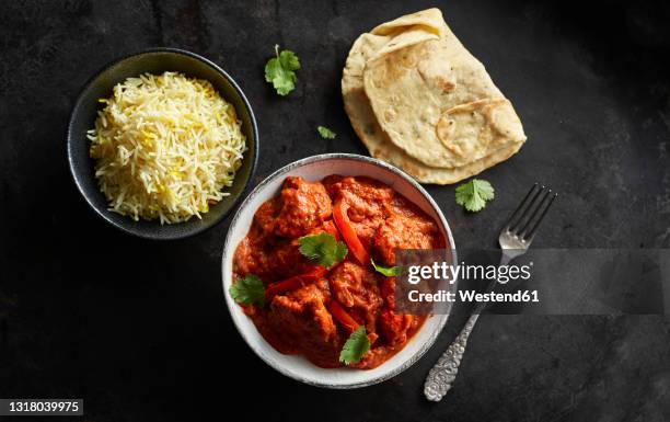 studio shot of bowl of chicken tikka, bowl of basmati rice and naan bread - tikka masala stock pictures, royalty-free photos & images