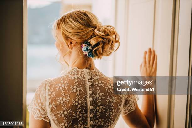 blond bride with hair bun wearing wedding dress - hair bun back stock pictures, royalty-free photos & images