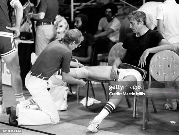 Former NBA player Dave DeBusschere has his knee wrapped with a bandage during the 3 on 3 Celebrity Basketball Tournament on September 7, 1978 at the...