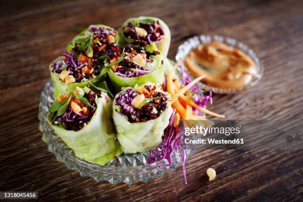 cabbage rolls with black rice, sesame seeds, carrot and red cabbage - black rice stock pictures, royalty-free photos & images