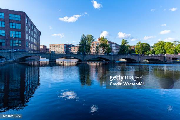 finland, pirkanmaa, tampere, city arch bridge stretching over tammerkoski river - tampere stock pictures, royalty-free photos & images