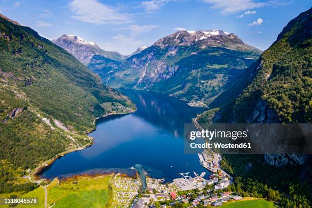 norway, more og romsdal, scenic view of secluded village in geiranger fjord - geiranger stock pictures, royalty-free photos & images