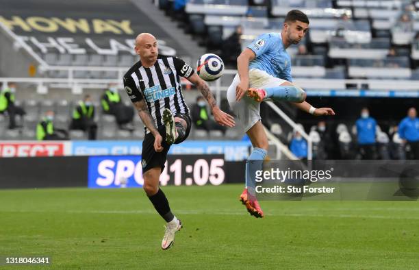 Ferran Torres of Manchester City flicks the ball in for the second City goal as Jonjo Shelvey challenges during the Premier League match between...