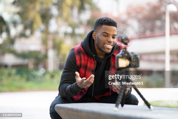male influencer vlogging at park - male influencer stock pictures, royalty-free photos & images