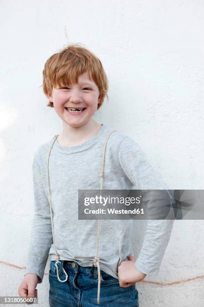 smiling redhead boy standing in front of wall outdoors - 7 stock-fotos und bilder