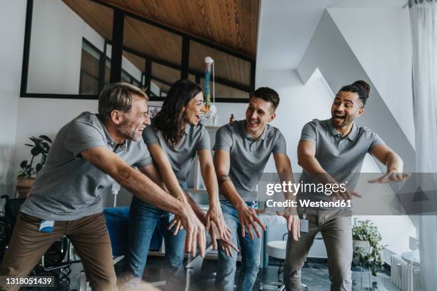 physiotherapists laughing while doing la ola wave in practice - mexican wave stock pictures, royalty-free photos & images
