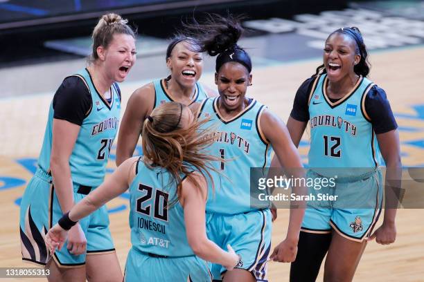 The New York Liberty celebrate after Sabrina Ionescu made a three-point basket in the final seconds of the second half against the Indiana Fever at...