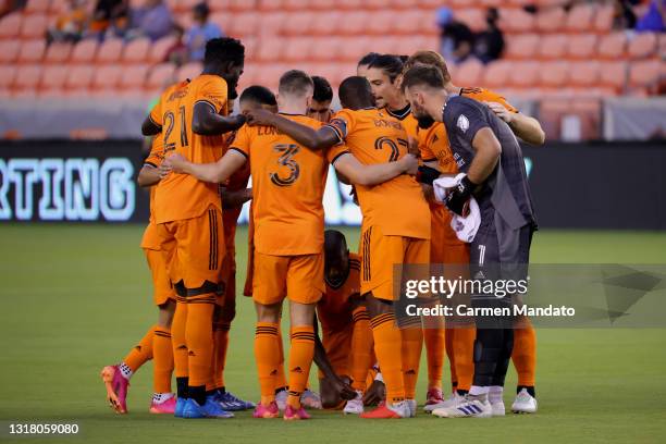 The Houston Dynamo huddle prior to a game against the Sporting Kansas City at BBVA Stadium on May 12, 2021 in Houston, Texas.