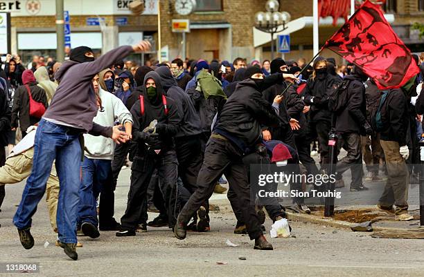 Anarchist protesters throwing stones at the riot police as fighting breaks out during a demonstration against the EU Summit June 15, 2001 in...