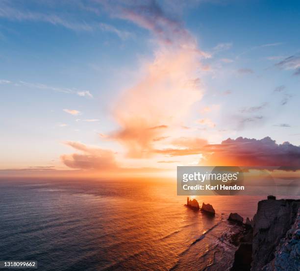 a daytime view of the needles lighthouse, isle of wight - stock photo - sunset stockfoto's en -beelden