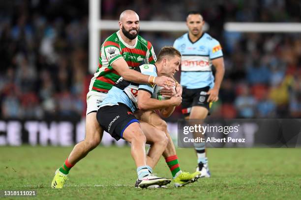 Matt Moylan of the Sharks is tackled during the round 10 NRL match between the Cronulla Sharks and the South Sydney Rabbitohs at Suncorp Stadium, on...