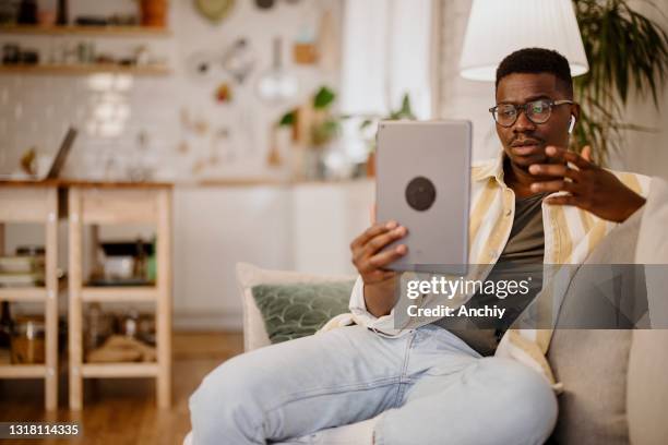 young man having online mental health session - virtual care stock pictures, royalty-free photos & images