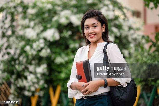 young female student holding books and backpack - indian college girl stock pictures, royalty-free photos & images