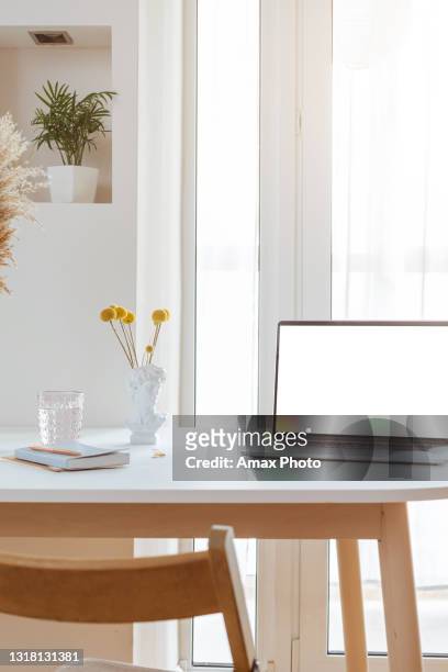 laptop with blank white screen in office desk interior. stylish workplace mockup. - home office ergonomics stock pictures, royalty-free photos & images