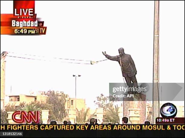 Statue of Iraqi President Saddam Hussein is torn down in Firdos Square in downtown Baghdad, Iraq, on April 9 as seen in this CNN frame grab.