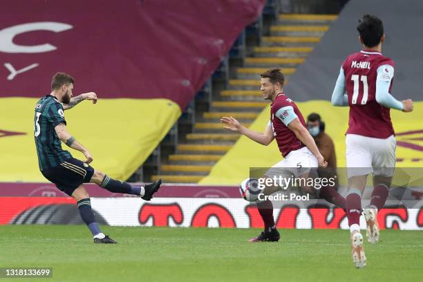 Mateusz Klich of Leeds United scores their side's first goal whilst under pressure from James Tarkowski of Burnley during the Premier League match...