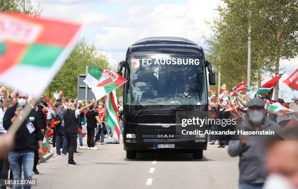 Fans greet The FC Augsburg team bus as it arrives at the stadium prior to the Bundesliga match between FC Augsburg and SV Werder Bremen at WWK-Arena...