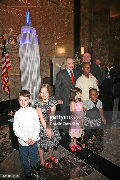 New York City Police Commissioner Raymond Kelly and children of families of honored NYPD officers light the Empire State Building on May 9, 2011 in...