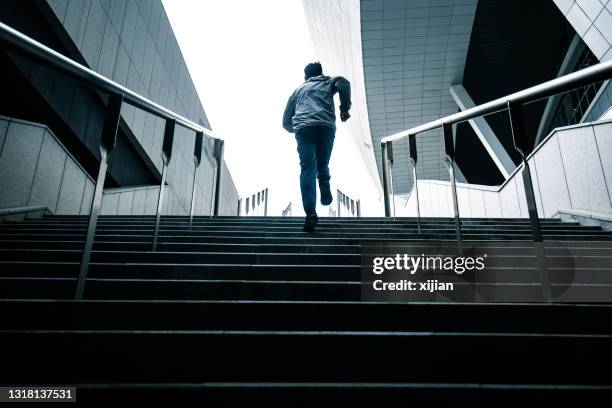 young man running up the stairs - slow motion stock pictures, royalty-free photos & images